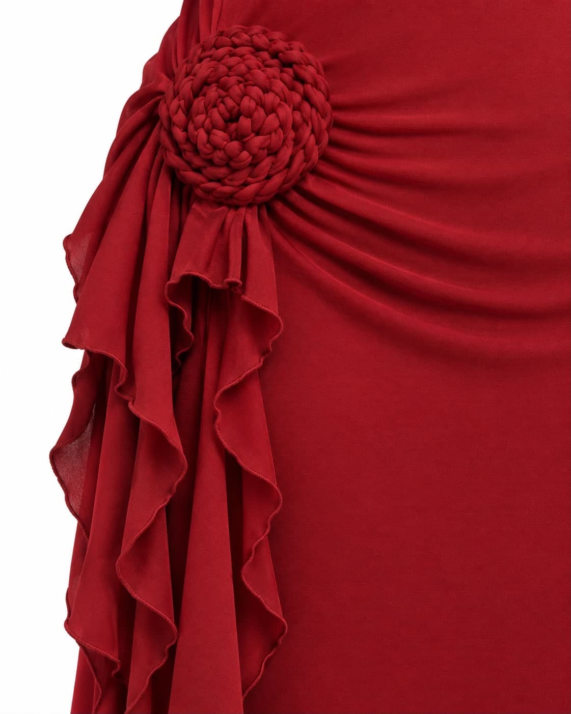 Close-up of a fabric rosette and the ruffle cascade on the red jersey gown