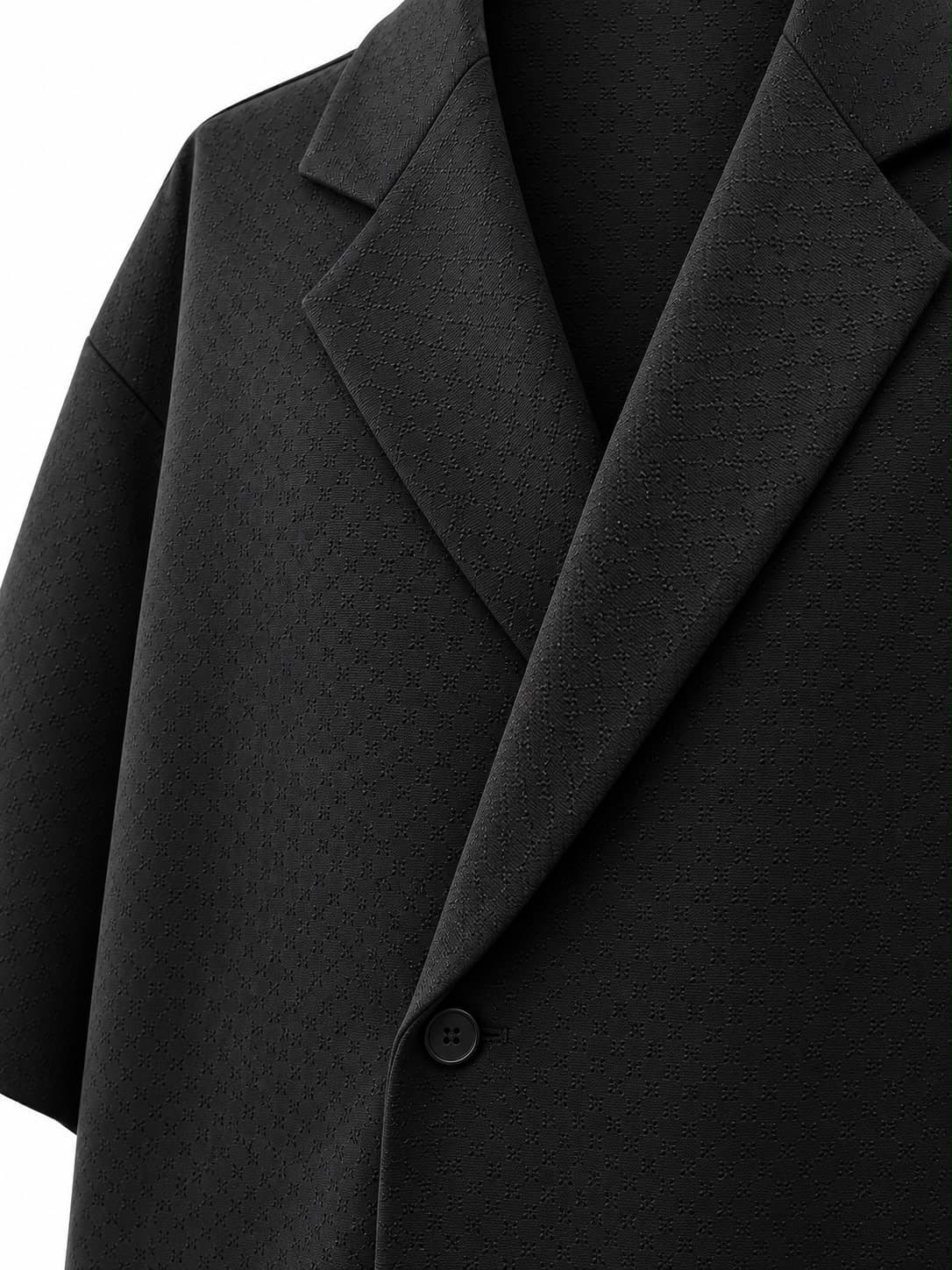 Close-up of the lapel and wrap front of the black oversized jacket