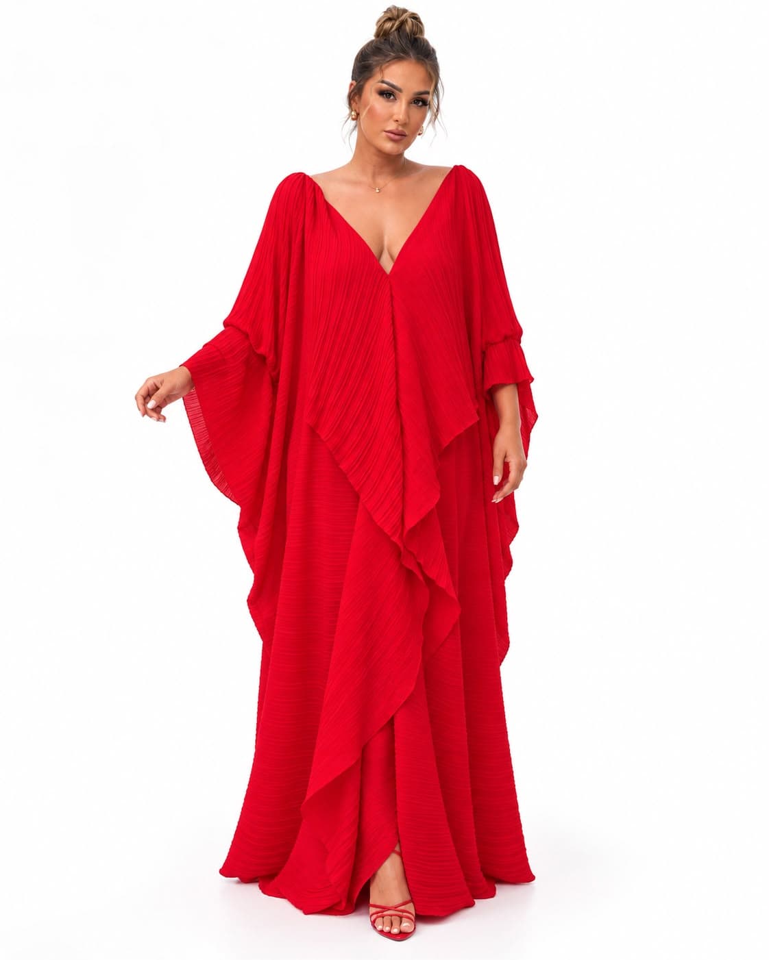 Model wearing the red micro-pleated kaftan with cape sleeves and a deep V neckline, full length