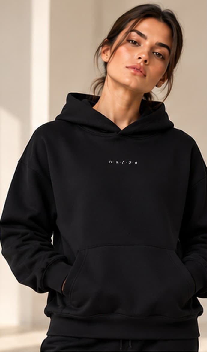 Brada Noir Hoodie worn with matching black joggers, front view