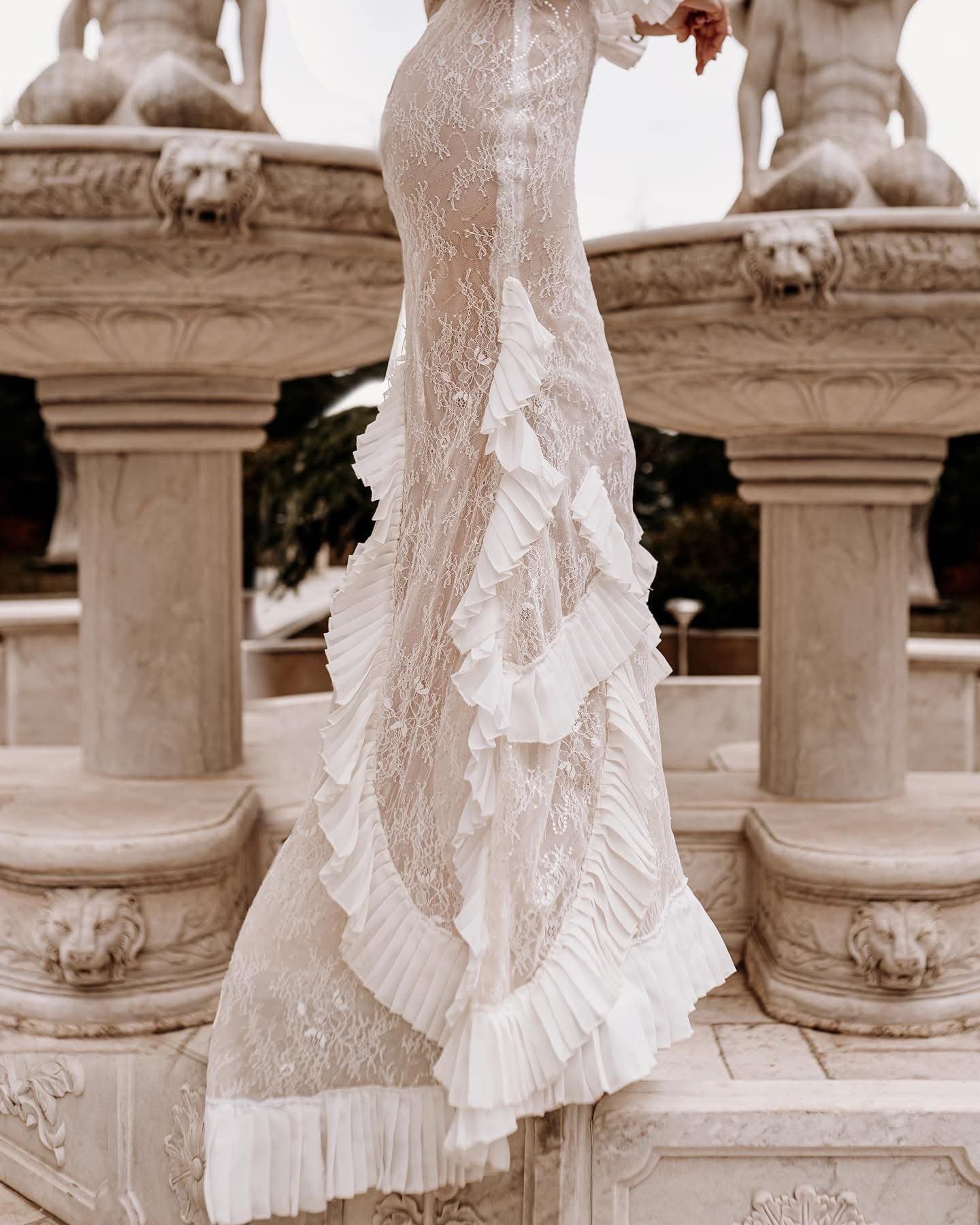 Detail of the ruffled lace skirt and train of the Volant Dentelle Gown
