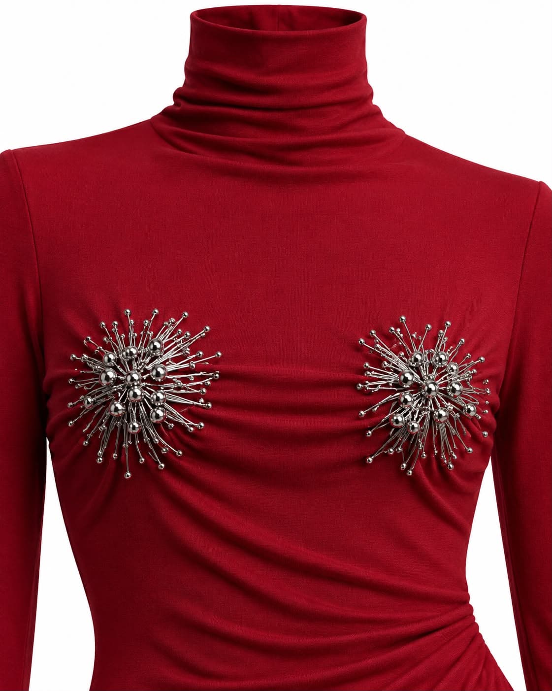 Close-up of the two crystal starburst brooches at the bust of the red turtleneck gown
