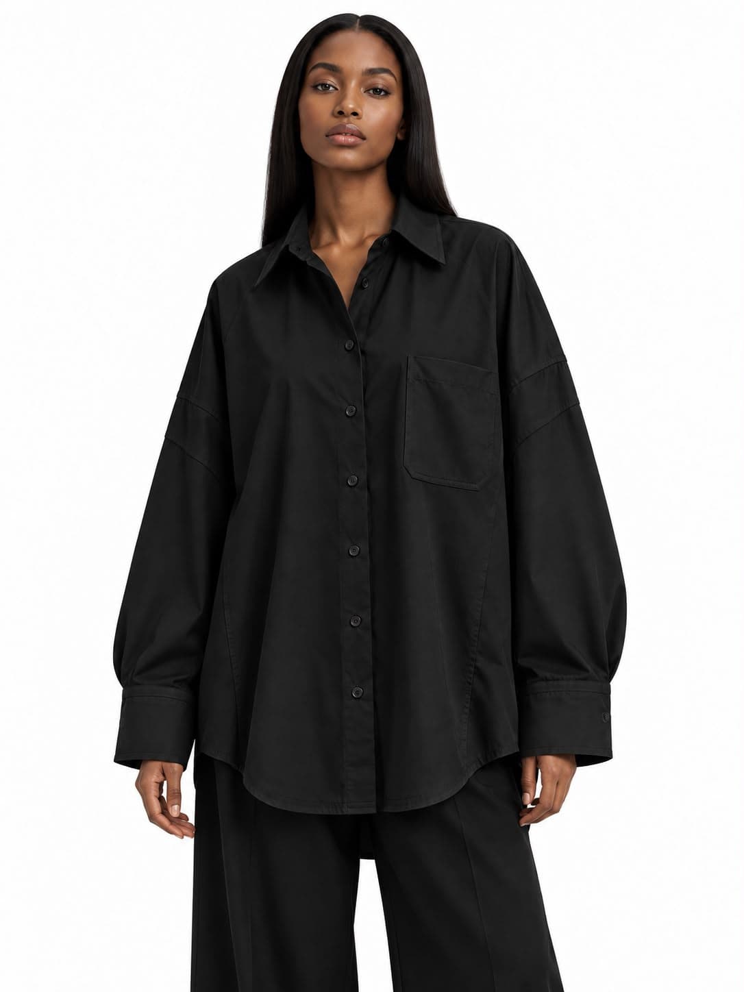 Noir Oversized T-Shirt worn with wide black trousers, front view